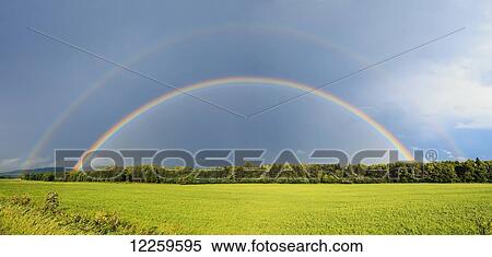 Double rainbow over trees and lush green field; Quebec, Canada View Large Photo Image Stock Photography - Double rainbow over trees and lush green field; Quebec, Canada. Fotosearch