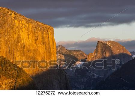 Stock Image - El Capitan and Half Dome in late afternoon winter light, as seen from Turtleback Dome in Yosemite National Park; California, United States of America. Fotosearch