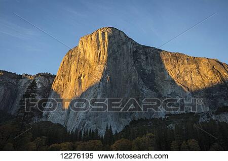 Stock Photography - El Capitan (El Cap) bathed in late afternoon fall light in Yosemite Valley, Yosemite National Park; California, United States of America. Fotosearch
