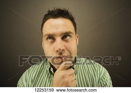 Stock Photo - Expressive portrait of a man; Edmonton, Alberta, Canada. Fotosearch