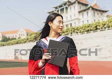 Picture - Female student at University graduation; Xiamen, Fujian, China. Fotosearch