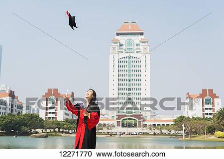 Stock Image - Female student at University graduation; Xiamen, Fujian, China. Fotosearch