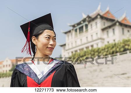 Stock Image - Female student at University graduation; Xiamen, Fujian, China. Fotosearch
