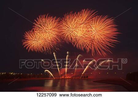 Stock Photo - Fireworks reflecting on a lake; Calgary, Alberta, Canada. Fotosearch