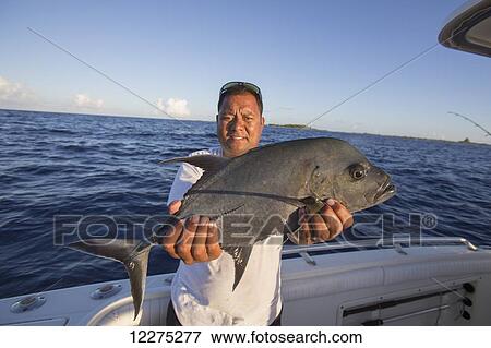 Fisherman holding fresh caught Jack fish (Carangidae); Tahiti View Large Photo Image Stock Photo - Fisherman holding fresh caught Jack fish (Carangidae); Tahiti. Fotosearch