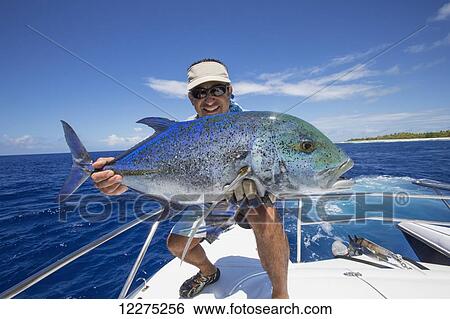 Fisherman holds a fresh caught Jack Fish; Tahiti View Large Photo Image Stock Photograph - Fisherman holds a fresh caught Jack Fish; Tahiti. Fotosearch