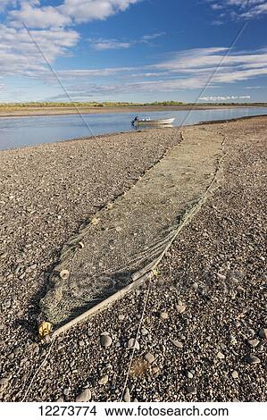 Picture - Fishing nets stretched out along the rocky banks of the Noatak River; Noatak, Alaska, United States of America. Fotosearch