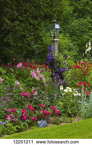 Flower garden and lamp post; Knowlton, Quebec, Canada View Large Photo Image Stock Image - Flower garden and lamp post; Knowlton, Quebec, Canada. Fotosearch