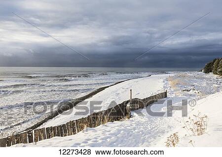 Stock Photo - Fresh snow on the beach; Homer, Alaska, United States of America. Fotosearch
