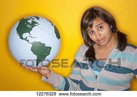 Stock Photo - Girl holding a globe; Edmonton, Alberta, Canada. Fotosearch
