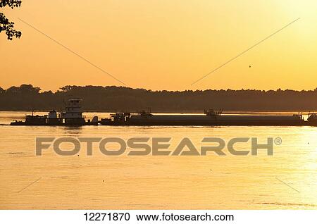 Grain barge navigating the Mississippi River in late afternoon light, near Memphis; Tennessee, United States of America View Large Photo Image Stock Image - Grain barge navigating the Mississippi River in late afternoon light, near Memphis; Tennessee, United States of America. Fotosearch