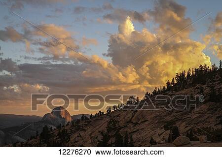 Stock Image - Half Dome at sunset during the Meadow Fire, as seen from near Olmsted Point along the Tioga Pass Road in Yosemite National Park; California, United States of America. Fotosearch