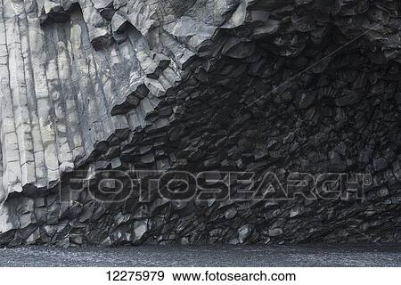Stock Photo - Hexagonal basalt columns rise out of the earth near the beaches of Vik; Iceland. Fotosearch