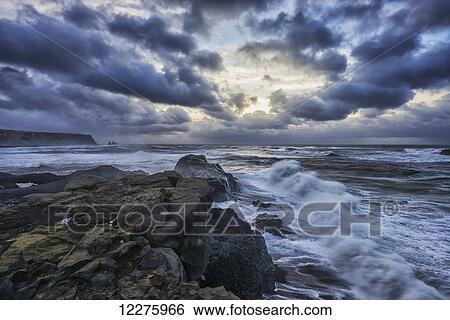 Stock Photograph - Huge waves crash along the shores of Dyrholaey, along the southern shores of Iceland; Iceland. Fotosearch