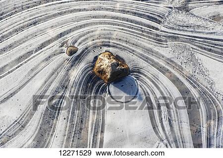 Ice formed around stones at the edge of a lake; Yorkshire, England View Large Photo Image Stock Photo - Ice formed around stones at the edge of a lake; Yorkshire, England. Fotosearch