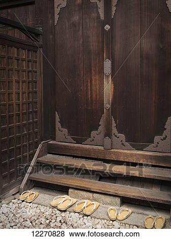 Japanese shrine with wooden door and slippers on rock steps; Kyoto, Japan View Large Photo Image Stock Photo - Japanese shrine with wooden door and slippers on rock steps; Kyoto, Japan. Fotosearch