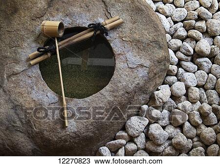 Stock Image - Japanese temple stone water fountain; Kyoto, Japan. Fotosearch