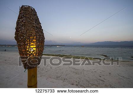 Lamp on the beach at dusk, Gili Trawangan, West Nusa Tenggara, Indonesia View Large Photo Image Stock Image - Lamp on the beach at dusk, Gili Trawangan, West Nusa Tenggara, Indonesia. Fotosearch