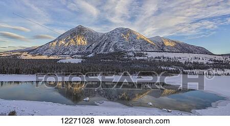 Stock Photo - Late winter afternoon light warms up the mountains along the Takhini River, near Whitehorse; Yukon, Canada. Fotosearch