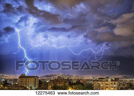 Stock Image - Lightning lights up the night skies above the city of Cochabamba; Cochabamba, Bolivia. Fotosearch