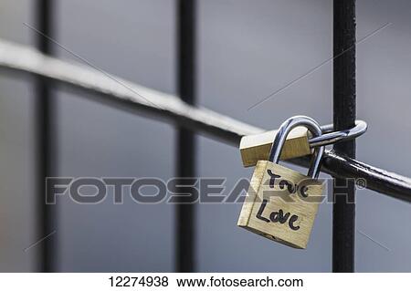 Stock Photo - Linked padlocks with message of true love attached to the High Level Bridge; Edmonton, Alberta, Canada. Fotosearch