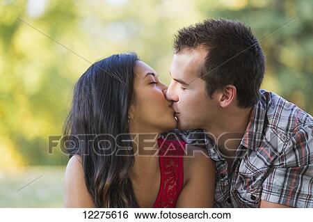 Mixed race couple kissing in a park in autumn; St. Albert, Alberta, Canada View Large Photo Image Stock Photograph - Mixed race couple kissing in a park in autumn; St. Albert, Alberta, Canada. Fotosearch
