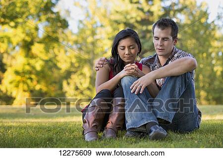 Mixed race couple praying together in a park in autumn; St. Albert, Alberta, Canada View Large Photo Image Stock Photo - Mixed race couple praying together in a park in autumn; St. Albert, Alberta, Canada. Fotosearch