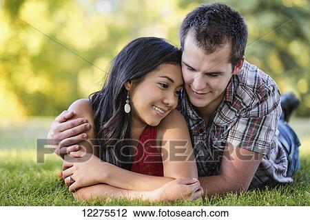Mixed race couple spending quality time together in a park in autumn; St. Albert, Alberta, Canada View Large Photo Image Stock Image - Mixed race couple spending quality time together in a park in autumn; St. Albert, Alberta, Canada. Fotosearch