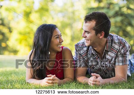 Mixed race couple spending quality time together in a park in autumn; St. Albert, Alberta, Canada View Large Photo Image Stock Image - Mixed race couple spending quality time together in a park in autumn; St. Albert, Alberta, Canada. Fotosearch