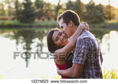 Mixed race couple spending quality time together in a park in autumn; St. Albert, Alberta, Canada View Large Photo Image Stock Image - Mixed race couple spending quality time together in a park in autumn; St. Albert, Alberta, Canada. Fotosearch