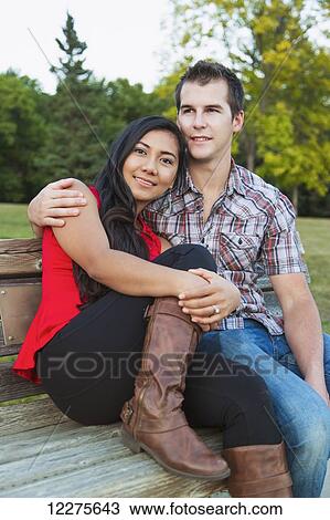 Mixed race couple spending quality time together in a park in autumn; St. Albert, Alberta, Canada View Large Photo Image Stock Image - Mixed race couple spending quality time together in a park in autumn; St. Albert, Alberta, Canada. Fotosearch
