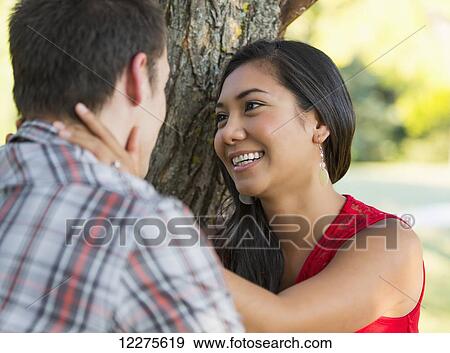 Mixed race couple spending quality time together in a park in autumn; St. Albert, Alberta, Canada View Large Photo Image Stock Photo - Mixed race couple spending quality time together in a park in autumn; St. Albert, Alberta, Canada. Fotosearch