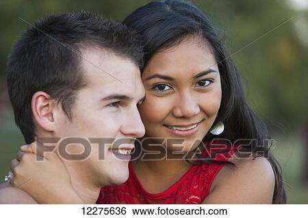 Mixed race couple spending quality time together in a park in autumn; St. Albert, Alberta, Canada View Large Photo Image Stock Photograph - Mixed race couple spending quality time together in a park in autumn; St. Albert, Alberta, Canada. Fotosearch