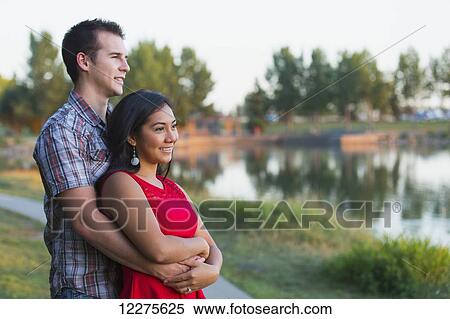 Mixed race couple spending quality time together in a park in autumn; St. Albert, Alberta, Canada View Large Photo Image Stock Photography - Mixed race couple spending quality time together in a park in autumn; St. Albert, Alberta, Canada. Fotosearch