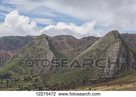 Stock Image - Near vertical sandstone beds form a sinuous hogs back of prominent, multicolored ridges in Toro Toro National Park; Bolivia. Fotosearch