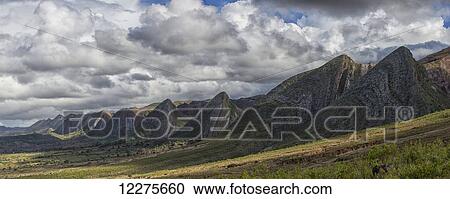 Stock Image - Near vertical sandstone beds form a sinuous hogs back of prominent, multicolored ridges in Toro Toro National Park; Bolivia. Fotosearch