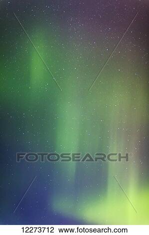 Stock Image - Northern Lights above a starry night sky in winter; Alaska, United States of America. Fotosearch