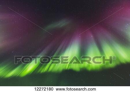 Stock Image - Northern Lights dance in clear skies above Barrow, Arctic Alaska; Alaska, United States of America. Fotosearch