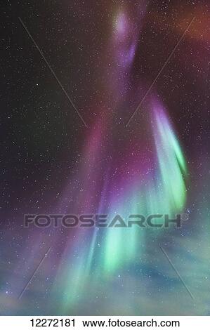 Stock Image - Northern Lights dance in clear skies above Barrow, Arctic Alaska; Alaska, United States of America. Fotosearch
