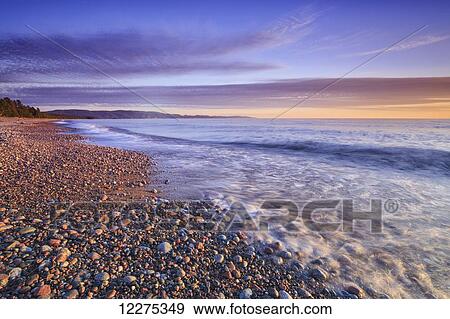Pebble beach on Lake Superior at dusk, Agawa Bay, Lake Superior Provincial Park; Ontario, Canada View Large Photo Image Stock Photo - Pebble beach on Lake Superior at dusk, Agawa Bay, Lake Superior Provincial Park; Ontario, Canada. Fotosearch