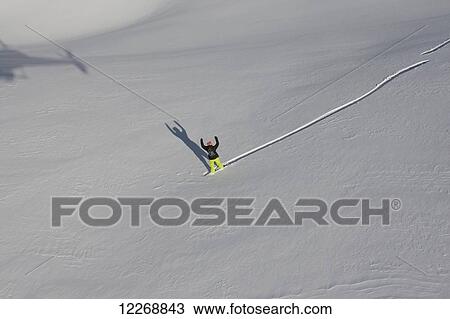 Stock Image - Person extreme snowboarding in mountains of New Zealand. Fotosearch