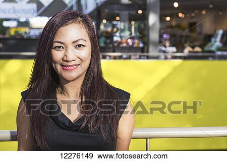 Stock Photo - Portrait of a businesswoman in a shopping complex; St. Albert, Alberta, Canada. Fotosearch