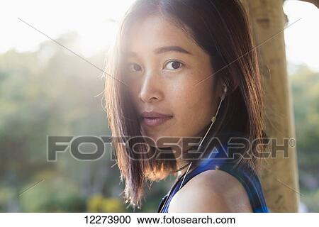 Portrait of a Chinese girl listening to music; Xiamen, Fujian province, China View Large Photo Image Stock Image - Portrait of a Chinese girl listening to music; Xiamen, Fujian province, China. Fotosearch
