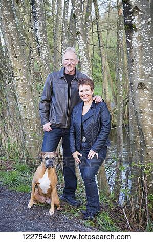 Portrait of a couple with their dog; British Columbia, Canada View Large Photo Image Stock Photo - Portrait of a couple with their dog; British Columbia, Canada. Fotosearch