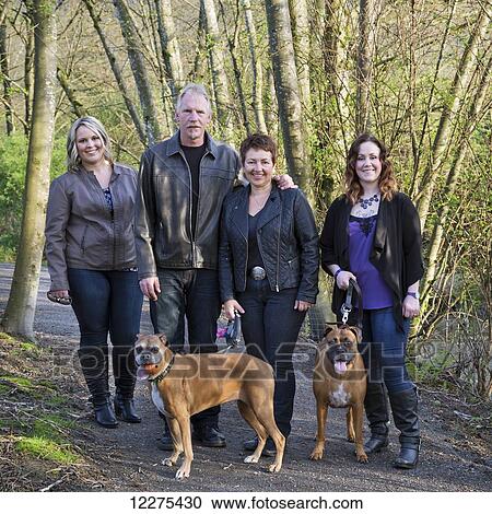 Stock Image - Portrait of a family with two daughters and two dogs; British Columbia, Canada. Fotosearch