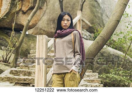 Stock Image - Portrait of a female model on a trail; Xiamen, China. Fotosearch