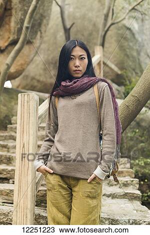 Stock Image - Portrait of a female model on a trail; Xiamen, China. Fotosearch
