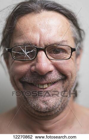 Portrait of a man with cracked glass on one side of his eyeglasses; Tarifa, Cadiz, Andalusia, Spain View Large Photo Image Stock Image - Portrait of a man with cracked glass on one side of his eyeglasses; Tarifa, Cadiz, Andalusia, Spain. Fotosearch