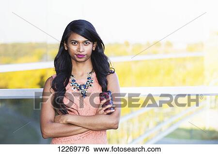 Stock Photograph - Portrait of a young professional businesswoman in downtown setting; Edmonton, Alberta, Canada. Fotosearch