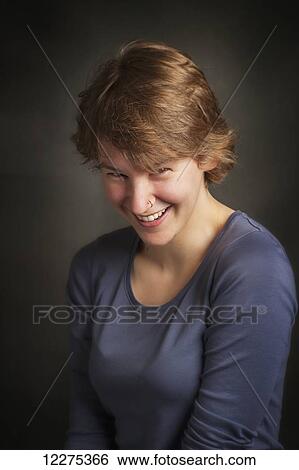 Stock Photograph - Portrait of a young woman laughing; United States of America. Fotosearch